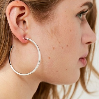 Model wearing silver hoop earring